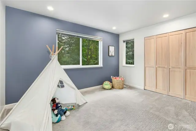 Spacious secondary bedroom, offering peaceful nature views.