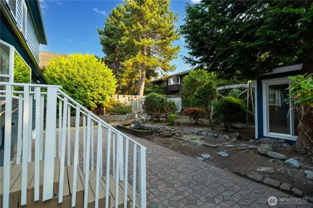 Backyard looking at outbuilding and pond