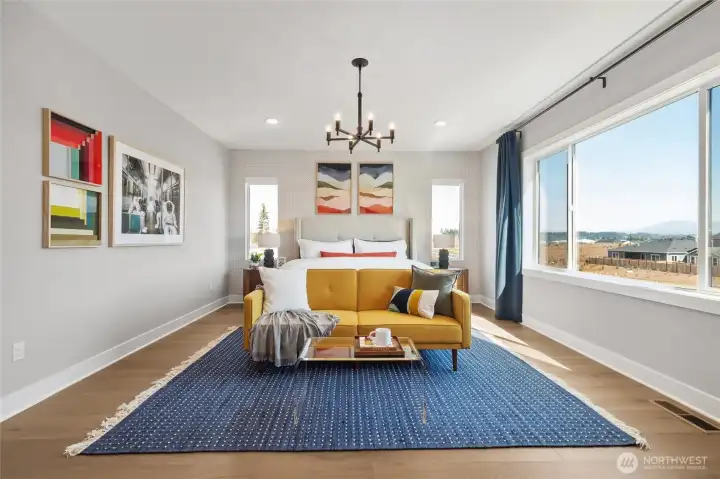 Primary bedroom is spacious, yet warm and homey.