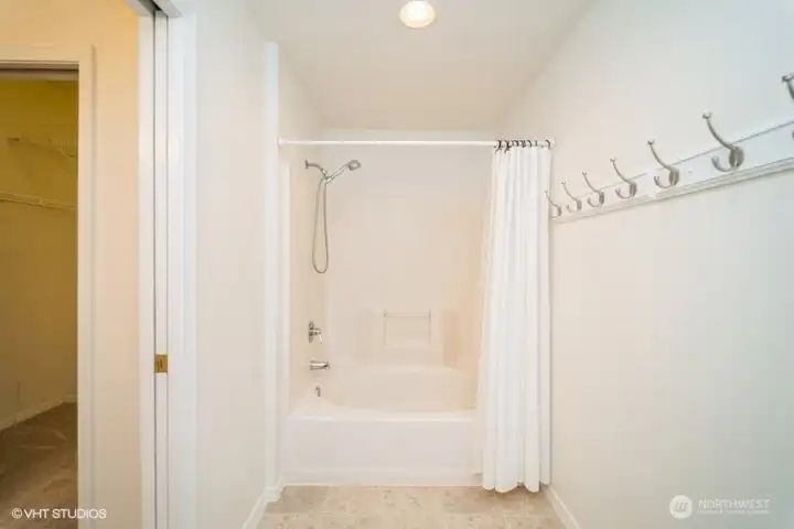 The primary bath boasts a soaking tub, perfect for relaxing after a long day.