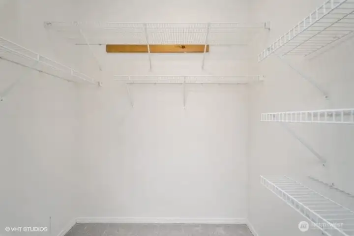 The primary suite features a spacious walk-in closet, perfect for keeping your wardrobe organized and easily accessible.
