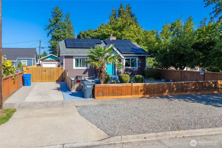 Tidy and beautiful are the words that come to mind when you arrive at this beautiful downtown Craftsman home. There's plenty of parking on both sides of the drive-thru gate and even more in the area shown here between the sidewalk and the road, so bring your cars and your toys!