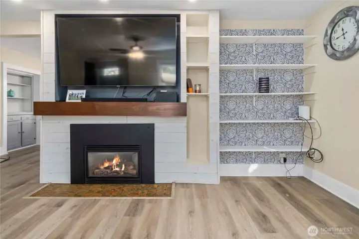 The wall-mount tv can stay with the home. Gorgeous mantel on the fireplace.