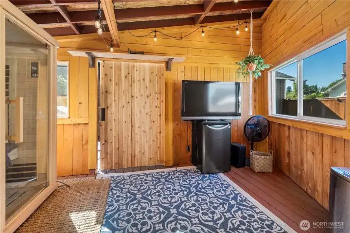 Here's another view of the outdoor room. The sellers enjoy the sauna and some tv in here. What a lovely place to take a sauna watching the snow fall in the winter time!