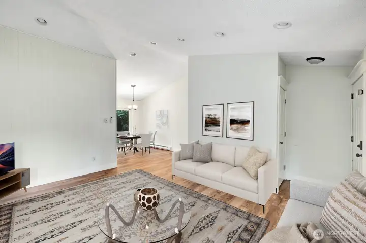 Living room with vaulted ceilings and fireplace.