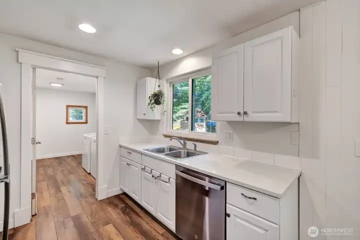 Updated kitchen with quartz counter tops, new cabinets and stainless steel appliances.
