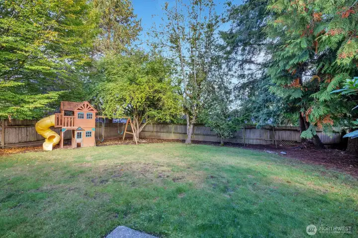 Fully fenced backyard is level and private.