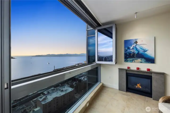 Open up the entire wall and enjoy the fresh air in your indoor wet room with gas fireplace