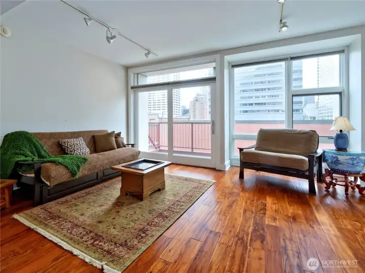 Living room with an abundance of natural light opens to private balcony.