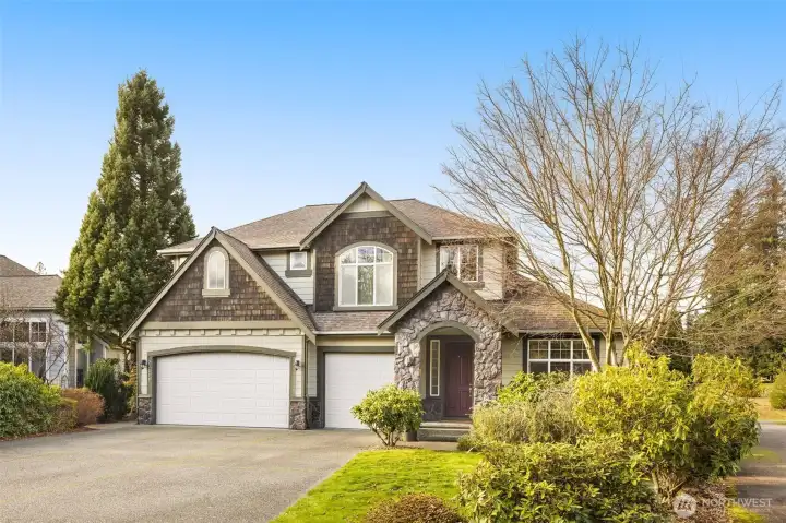 Cedar shakes and stone accents give this home dramatic curb appeal. Did you notice the 3-car garage?