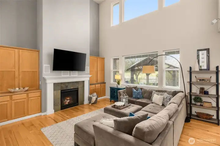 Clerestory windows drench this space in natural light. Gas fireplace adds cozy vibes at the flip of a switch.