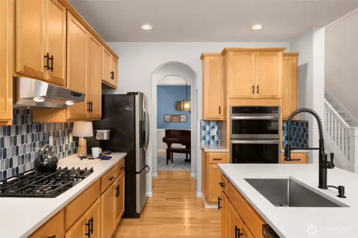 From the kitchen, looking to the formal dining room. Notice the double ovens and extra counter space.