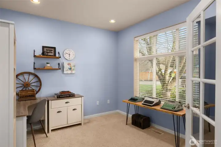 The office is just inside the front entry. Notice the glass French doors and large windows.