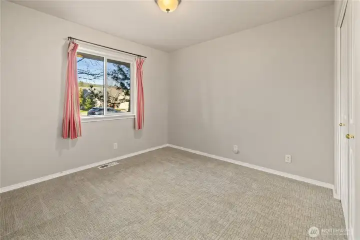 Extra Bedroom across from the Primary Bedroom. Has view of the front yard.
