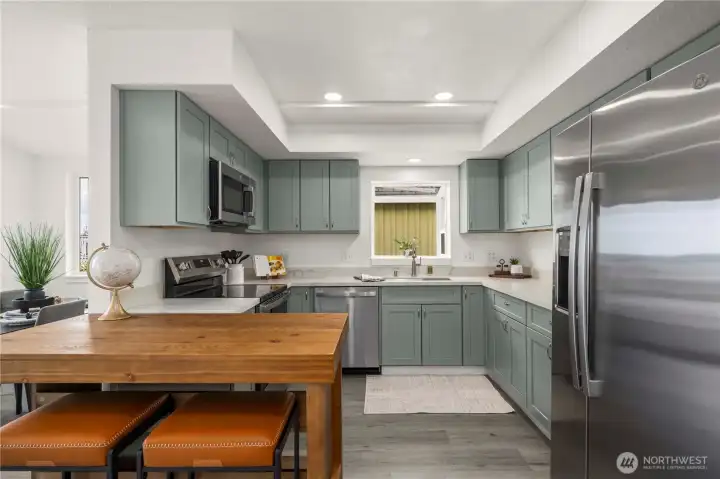 The kitchen offers brand new stainless steel appliances