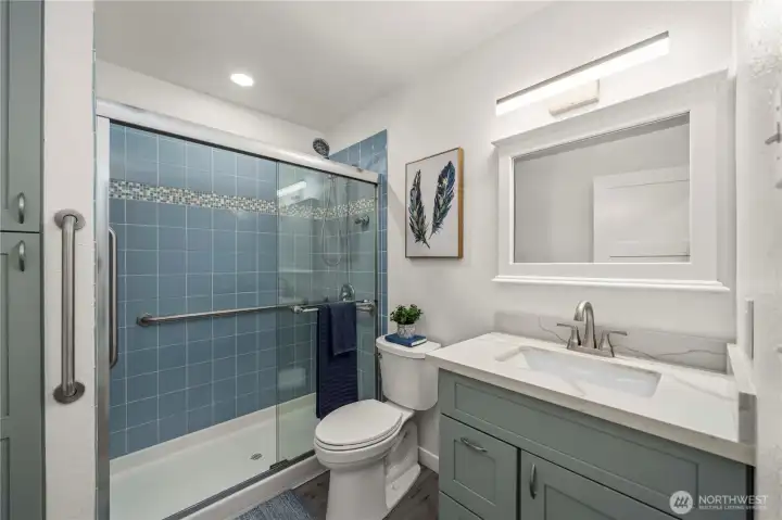 Main floor bathroom with updated vanity and storage