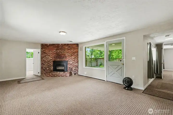 Another view of the living room, back door provides easy access to the backyard.