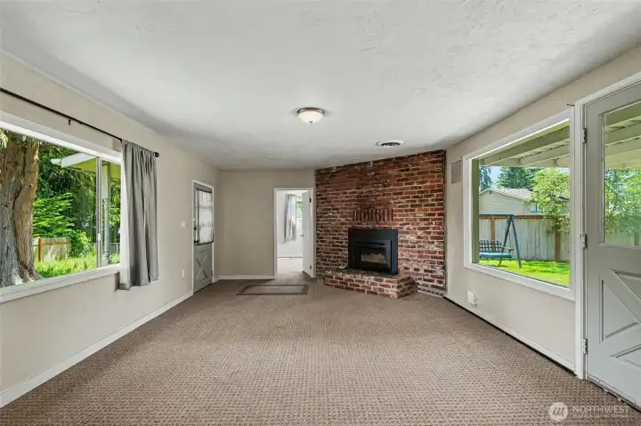 Positioned between two expansive windows, the living room enjoys an abundance of natural light throughout the day.