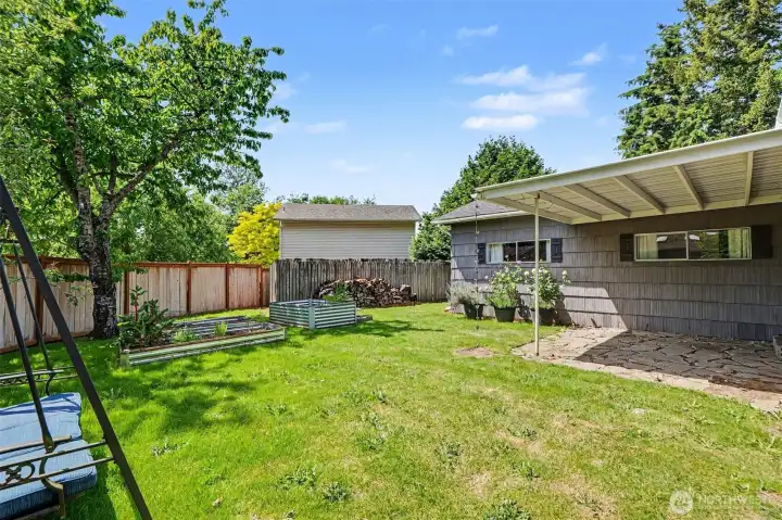 The covered patio with stone pavers provides the perfect setting for relaxing year-round.