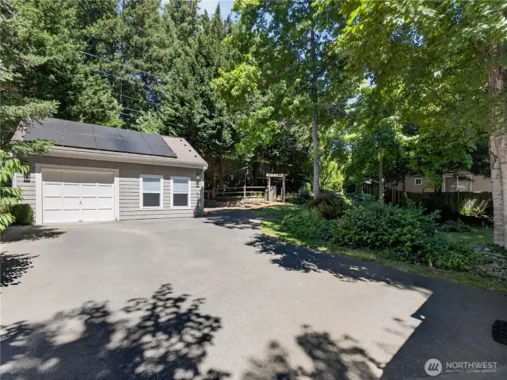 The detached garage offers exceptional flexibility with ample parking, storage, and workspace, while the expansive driveway provides generous room for guests and everyday convenience.