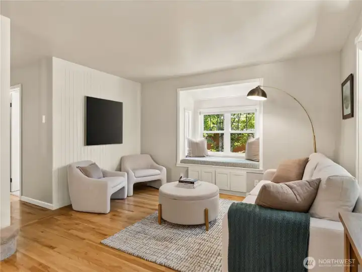 Large windows frame peaceful views of the surrounding greenery, while the charming window seat invites you to curl up with a good book or enjoy your morning coffee.