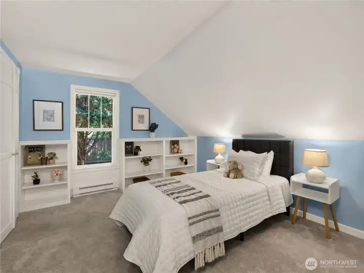 This versatile bedroom provides a comfortable setting for restful nights, a guest suite, or a creative personal space.