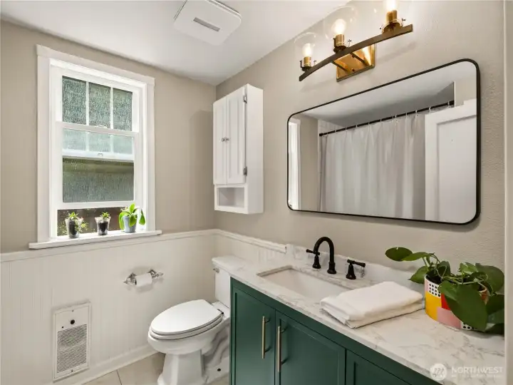 Beautifully refreshed with timeless style, this bathroom blends modern updates with classic charm.