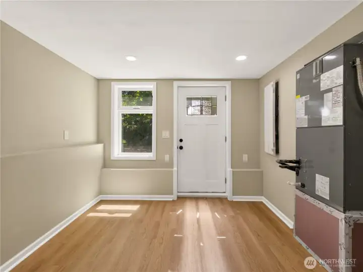 Another view of the bonus room, featuring an exterior door to the driveway for ultimate privacy. With durable flooring, recessed lighting, and its own exterior entrance, it offers exceptional potential as a home gym, hobby room, creative studio, workshop, storage area, or everyday flex space. See next photos for ideas/options for this space.