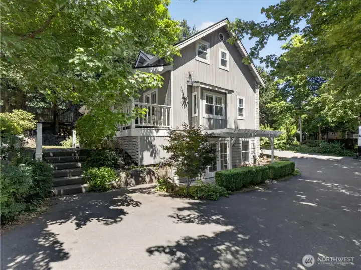 Nestled among towering evergreens and established gardens, this beautifully maintained home exudes warmth and timeless appeal.