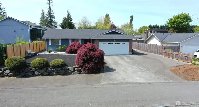 Additional parking in the front of the bushes and on the side of the home.
