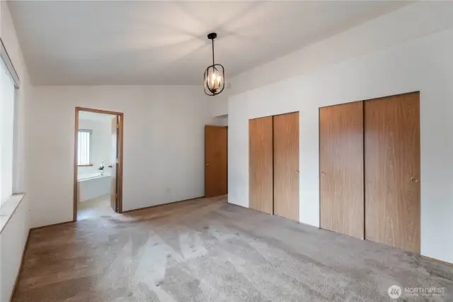 Primary bedroom with 2 closets and an ensuite