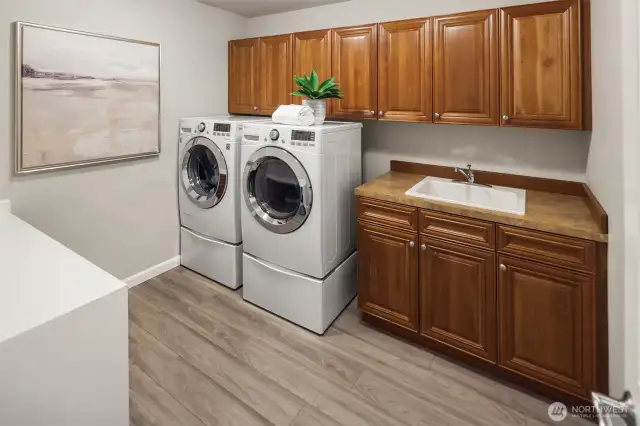 Extra large laundry room on the upper level loaded with storage.