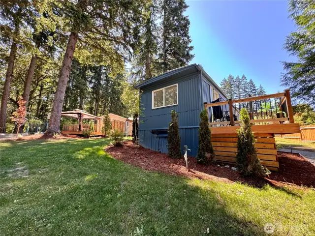 Lot's of outdoor spaces to enjoy. A tiny home and a big deck with a large pergola.