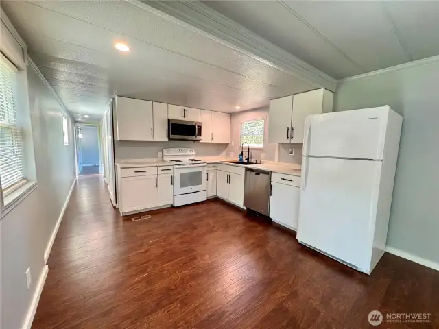 Updated kitchen complete with fridge, microwave, range and dishwasher. LVP flooring throughout.