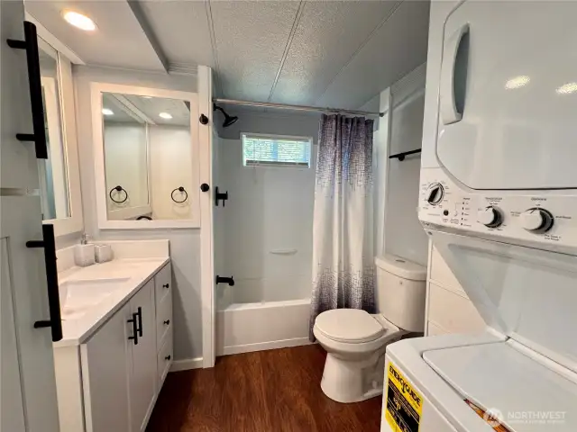 Updated bath complete with a stackable laundry set.