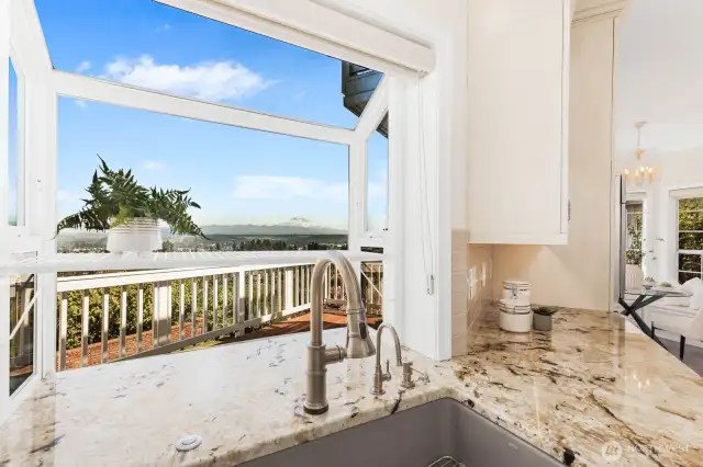 Doing dishes won't be so awful with views of Mt. Rainier! Slab countertops are impressive.