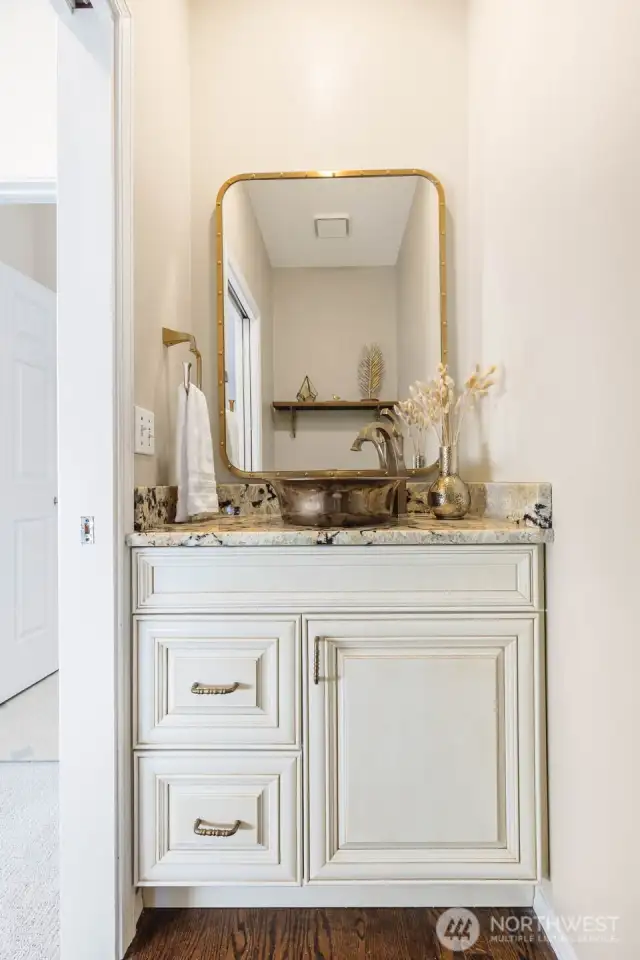 Updated half bath on the main floor. Designed to match kitchen finishes.