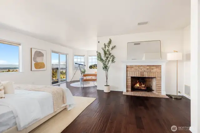 Welcome in through double doors to the primary suite. Gas fireplace with beautiful brick surround and wood mantle.