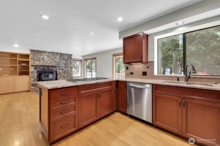 Updated Kitchen with Stainless appliances, Granite Slab and cherry cabinets.