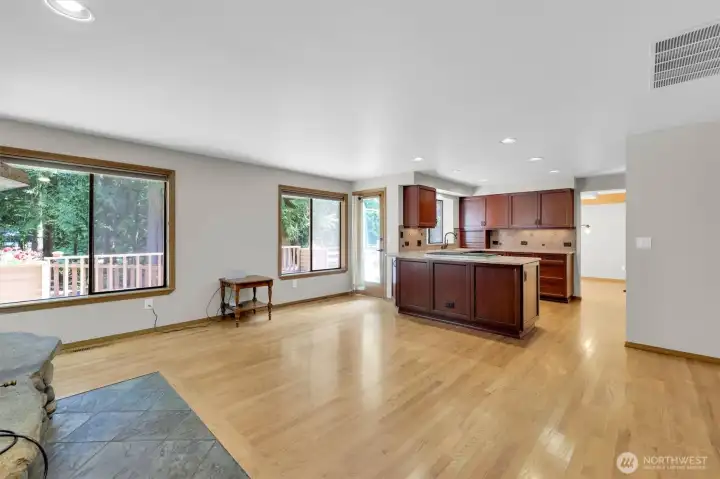 Another view of the family room showing the kitchen eating bar & door to deck.