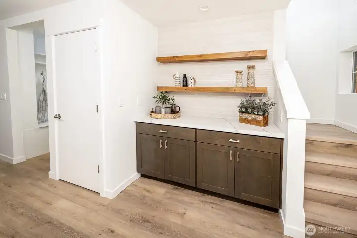 Designer element adds distinct quality to this space with this thoughtful built in buffet with floating shelves and lots of added storage.  A definite focal piece for this area.