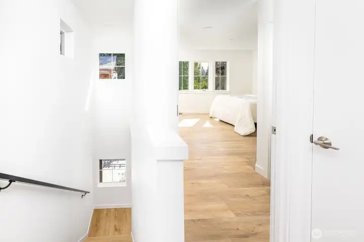 Stairway to top floor is drenched in natural light.