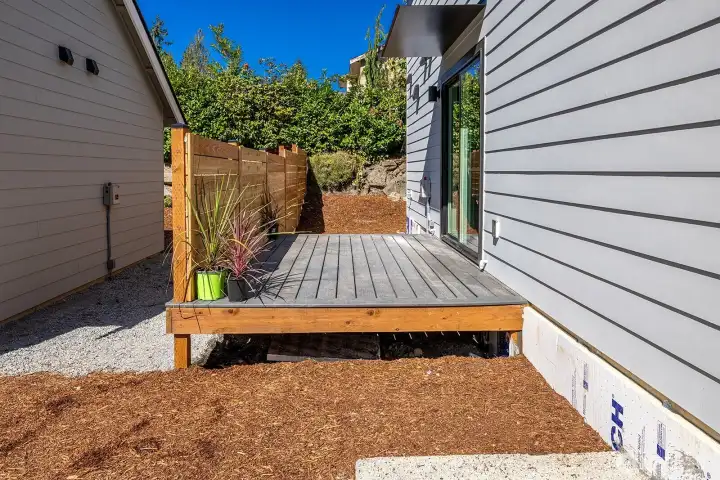 Railings will be added anyday, but this shot gives you an idea of the southern sun exposure and the space of the deck.  Side yard space is very low maintenance but allows for gardening, games or a space for a fur friend.