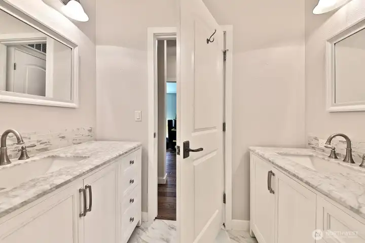 Full bath with two sinks/vanities. This bathroom is located in the hallway next to the 2nd bedroom and two flex rooms.
