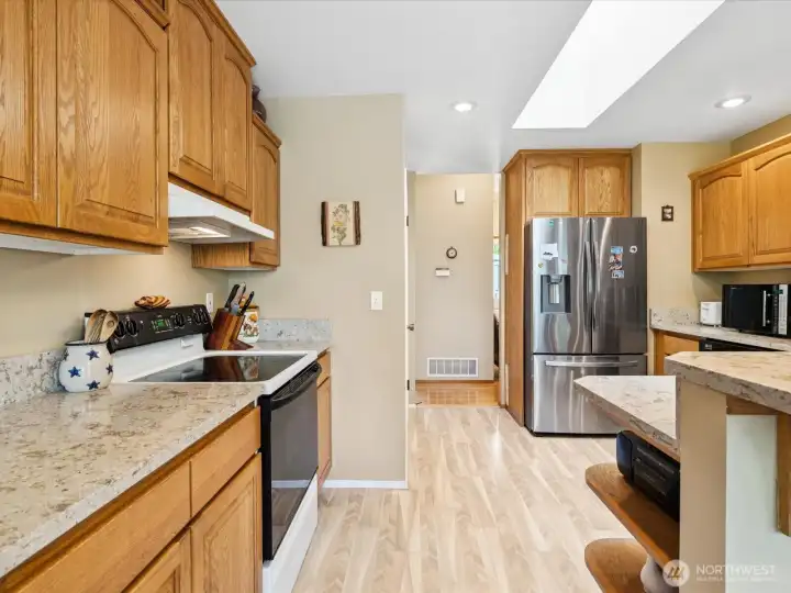 Quartz countertops, hardwood floors, and skylights.