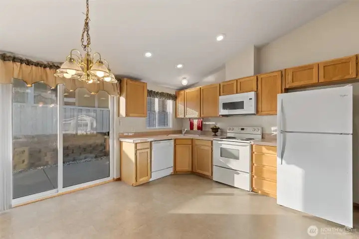 Kitchen and dining space open to private western patio