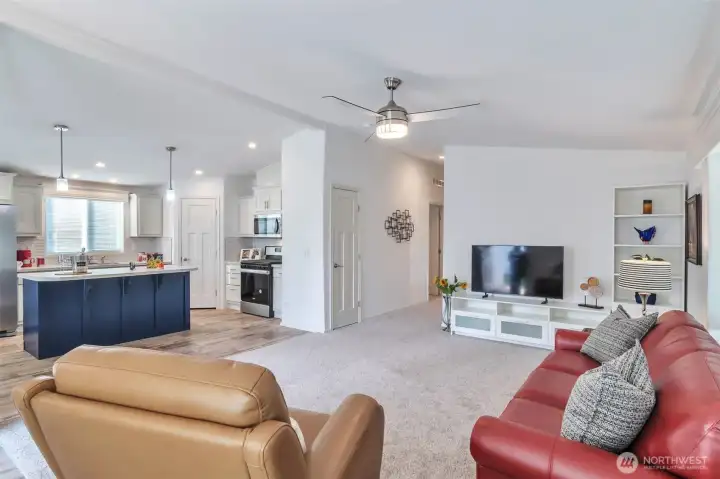 Living area with vaulted ceiling, coat/storage closet, plenty of space for entertainment center, chunky sofa or sectional, plus chairs.  Ceiling fan for summer days.