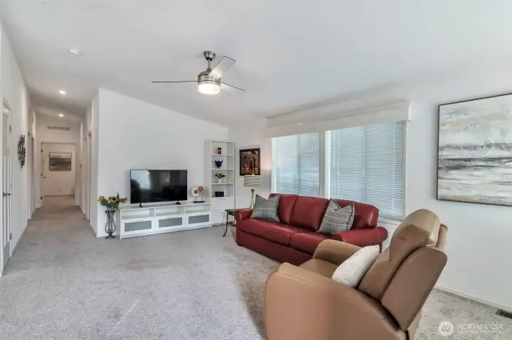 Vaulted ceilings contribute to spacious feel in concert with natural window light, recessed lighting, and fresh and bright palette throughout.