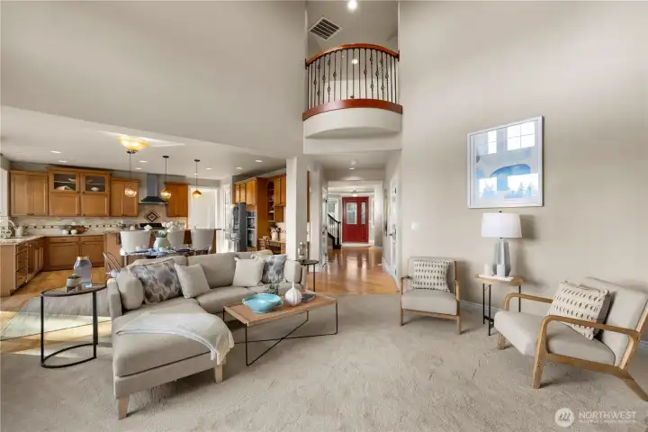 The double height living room off the kitchen is the perfect place to entertain or lounge with the family.