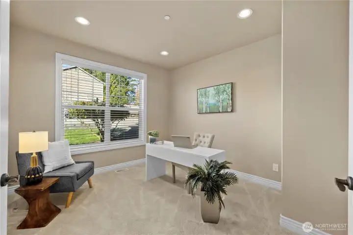 At the front of the house by the foot of the stairs in an office/den.